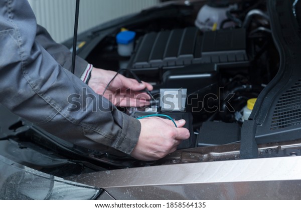 Auto electrician. Work of an
auto electrician in a car service station.Checking the
car.