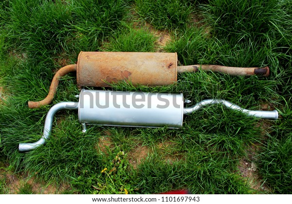 auto exhaust\
system old rusty and new\
muffler
