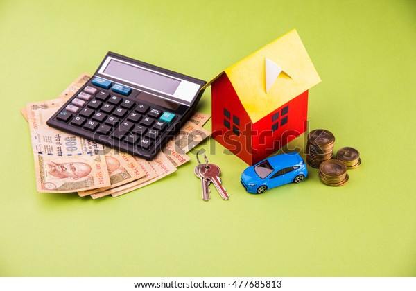 Auto Finance and Housing Loan or purchase in India - \
Concept showing 3D Car and house model, keys, indian currency notes\
and calculator etc