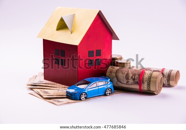 Auto Finance and Housing Loan or purchase in India - \
Concept showing 3D Car and house model, keys, indian currency notes\
and calculator etc