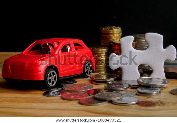 AUTO FINANCING CONCEPT :\
Small cars,coins,piece of puzzle and calculator on wooden table.\
Copy Space