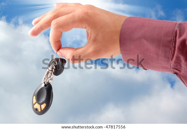 auto keys in a hand\
on a white background