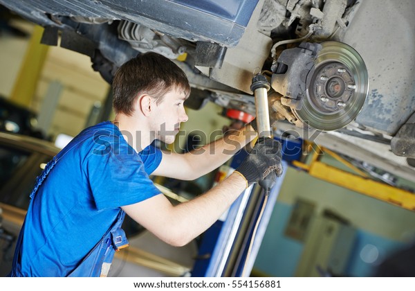 auto mechanic at car
suspension repairing