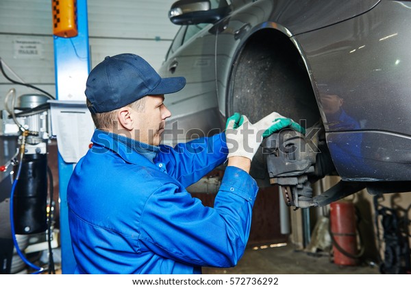 auto mechanic at car
suspension repairing