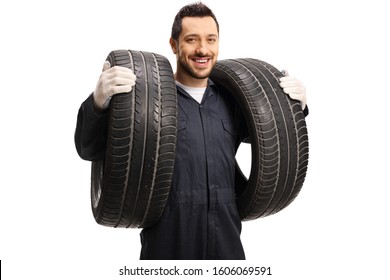 An Auto Mechanic Carrying Two Car Tires Isolated On White Background