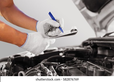 Auto Mechanic Checking Car Engine At The Garage