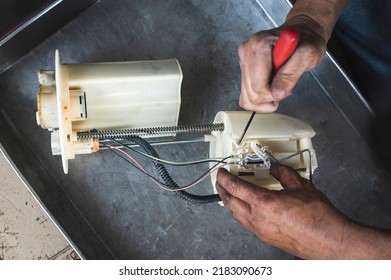 Auto Mechanic Checking Car Fuel Pump Module. 