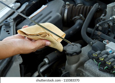 Auto Mechanic Checking Oil