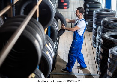 Auto Mechanic  Choose Tire For Car At A Tire Store