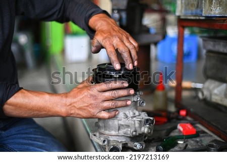 Auto mechanic disassembling starter motor