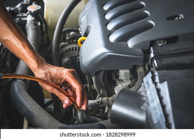 Auto Mechanic Filling The New CVT  Transmission Fluid In Automatic Transmission Fill Hole.