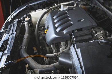 Auto Mechanic Filling The New CVT  Transmission Fluid In Transmission Fill Hole.