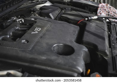 Auto Mechanic Filling The New CVT  Transmission Fluid In Transmission Fill Hole.