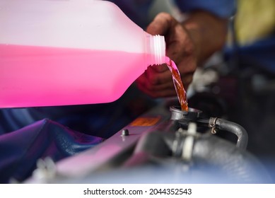 Auto Mechanic Filling Pre-mixed Super Long Life Coolant Fluid In Car Radiator Fill Hole.