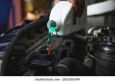 Auto Mechanic Filling Pre-mixed Super Long Life Coolant Fluid In Car Radiator Fill Hole.