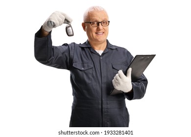 Auto mechanic holding a car key and a clipboard isolated on white background - Powered by Shutterstock