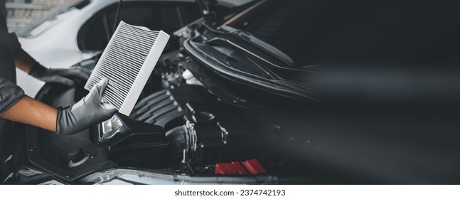 Auto mechanic holding old car air filter pollution to checking cleaning and replacing new for fix heat car air conditioner service maintenance. - Powered by Shutterstock