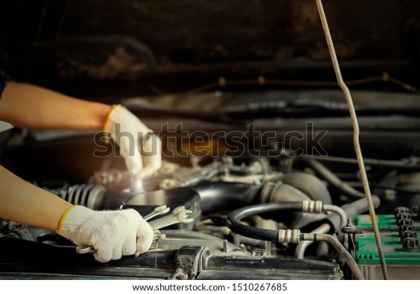Auto mechanic holds a wrench in hand 3 for
repair.Auto mechanic Preparing For the work.Car mechanic holding a
wrench in his hand.Close up of hands mechanic doing car service and
maintenance.