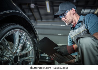 Auto Mechanic Job. Caucasian Car Service Technician With Vehicle Repairs History Report.