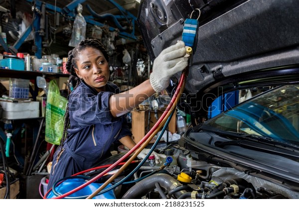 Auto mechanic monitor to check and fixed car\
air conditioner system in car garage. service car air conditioner\
in repair workshop. monitor tool on car engine ready to check and\
fixed air conditioner