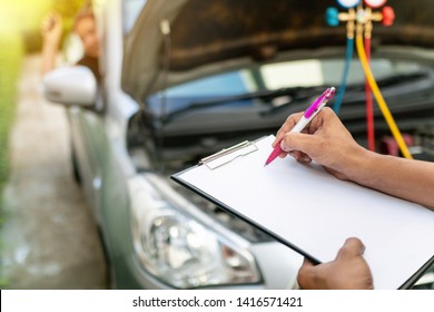 Auto Mechanic Perform Vehicle Checkup While Service Advisor Take Notes,Professional Auto Service Technician .