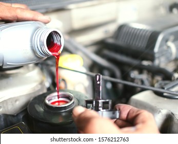 The auto mechanic is refilling additional brake fluid after the inspection and repair of the damaged parts. - Shutterstock ID 1576212763