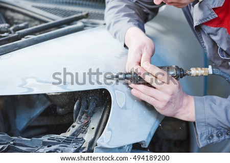 auto mechanic repairing car autobody bonnet