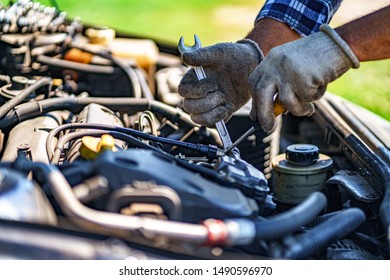 Auto mechanic repairing a car engine. Repair service  - Shutterstock ID 1490596970