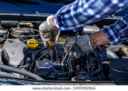 Auto mechanic repairing a car engine. Repair service 