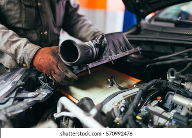 Auto mechanic repairing car. Selective focus. - Shutterstock ID 570992476