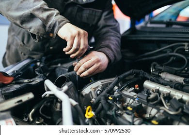 Auto mechanic repairing car. Selective focus. - Shutterstock ID 570992530