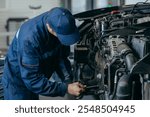 Auto mechanic repairs an engine. Replacing the timing chain