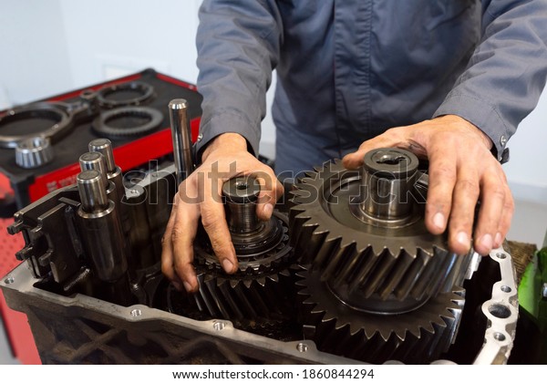 An auto mechanic repairs a truck engine.\
Service of trucks in the garage.\
Close-up