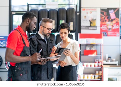 The Auto Mechanic Talking To Female Customer In Tires Shop, Car Auto Service, Garage	