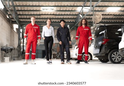 Auto mechanic team walking with smiling woman customer in repair garage ready to fix or maintenance broken engine cars parking in background. Diverse group of people at vehicle repair service shop. - Powered by Shutterstock