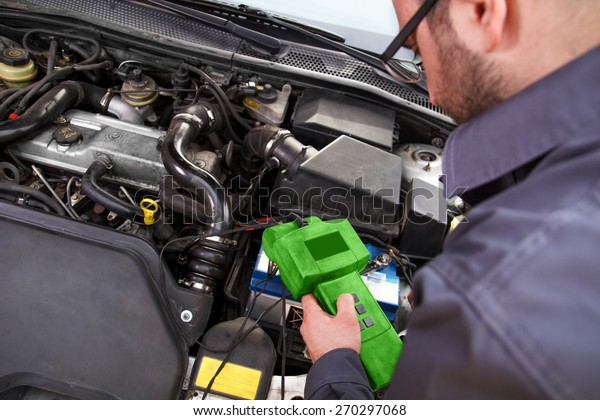 Auto\
mechanic testing the electrical system on\
automobile