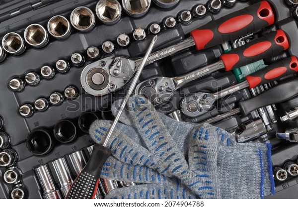 Auto\
mechanic tool kit and fabric gloves. View from\
above