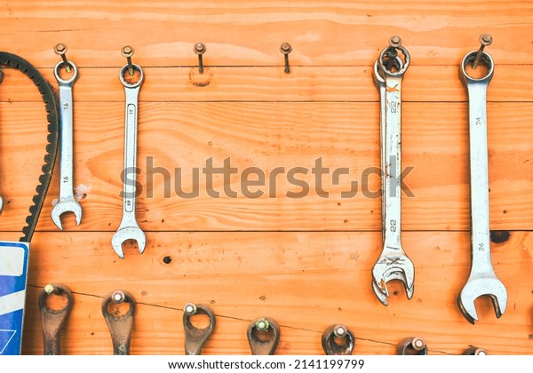 Auto mechanic tools pegboard on the wooden wall\
mount with copy space