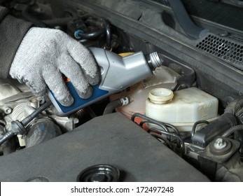 Auto Mechanic Topping Up Brake Fluid In The Vehicle