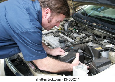 Auto Mechanic Under The Hood, Working On A Car Engine.