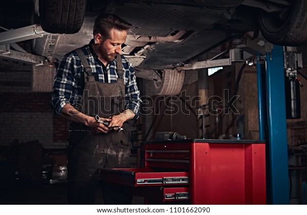 Auto Mechanic Uniform Working On Workbench Stock Photo Edit Now