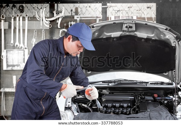 Auto mechanic use\
tool operation repaired engine at maintenance repair service\
station with tools\
background