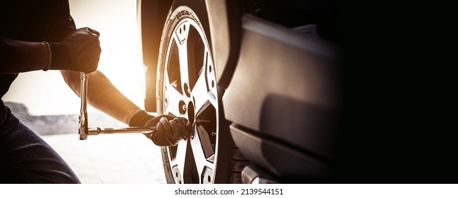 Auto Mechanic Use Wrench To Repairing And Change Car Tires. Concept Of Car Care Service And Maintenance Or Fix The Car Leaky Or Flat Tire.