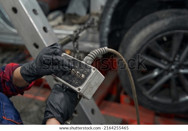 Auto mechanic using diagnostic equipment in care\
repair garage