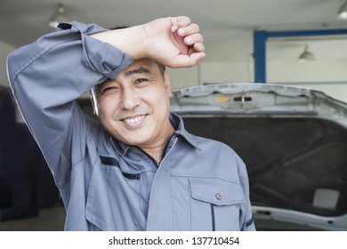 Auto Mechanic Wiping The Sweat Off His Brow