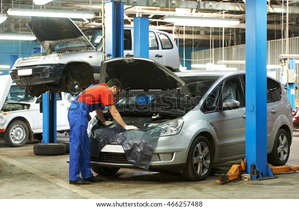 auto mechanic at work in\
garage