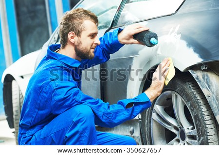 auto mechanic worker applying washing car body preparing for painting at automobile repair and renew service station