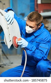 Auto Mechanic Worker Polishing Bumper Of Car Body At Automobile Repair And Renew Service Station Shop By Power Buffer Machine