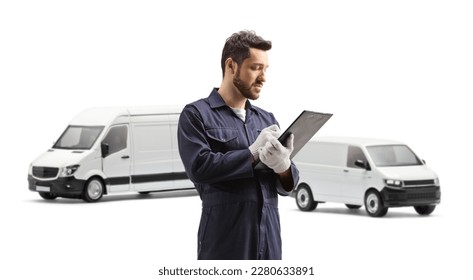Auto mechanic worker writing a document in front of two white vans isolated on white background - Shutterstock ID 2280633891