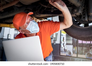 Auto Mechanic Working In Garage, Car Service Technician Checking And Repairing The Customer Car At Automobile Service Center, Inspecting Car Under Body And Suspension System, Vehicle Repair Shop.